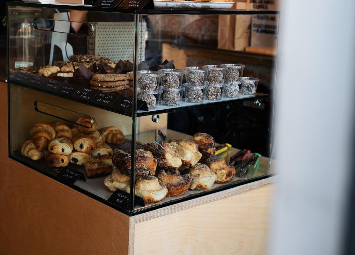 The pastry case at Glasthule: gingerbread biscuits, coconut and lemon bars, carrot cake, croissants and more, each on its own hand-written label.